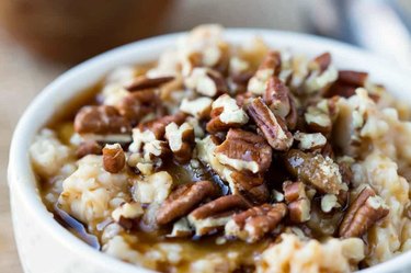 Slow cooker overnight pecan pie oatmeal in a white bowl