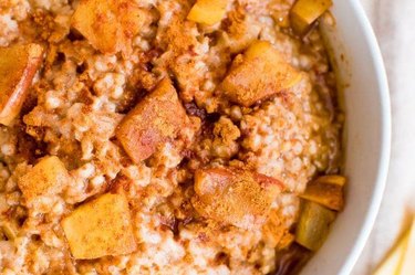 Slow cooker apple cinnamon oatmeal in a white bowl