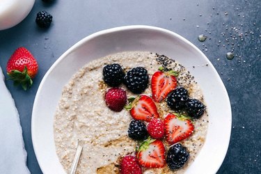 Overnight steel-cut oatmeal with berries in a white bowl