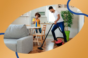 Father and child clean the house together to get more steps throughout the day