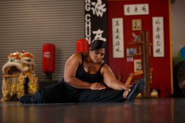 personne obèse faisant de l'exercice dans un dojo pour prévenir et retarder les douleurs articulaires