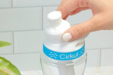 a close up photo of a hand adjusting a Cirkul water bottle flavor dial