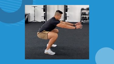 trainer showing correct air squat form in the gym