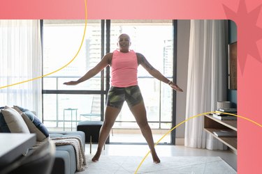 Woman doing jumping jacks as a warm-up before a leg workout in her living room