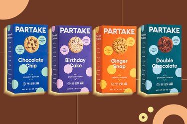 four boxes of partake cookies on brown background as example of health and fitness sale to shop right now