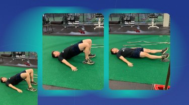 athletic man doing a glute bridge and hamstring curl exercise