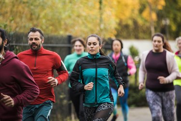 A group of people running outside as part of a running club.