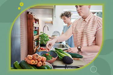 two people preparing a high-protein meal at home with vegetables