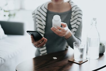 woman holding a bottle of gaba supplement