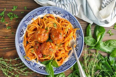 Plate of spaghetti and meatballs in a red sauce.