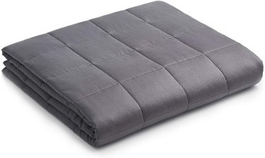 a gray folded weight blanket on a white background
