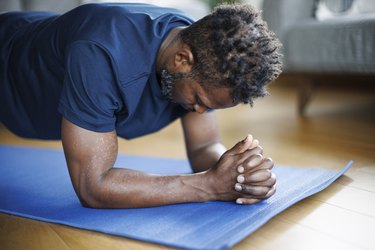 Close-up photo of person doing a forearm plank as one of the best exercises to do instead of push-ups.