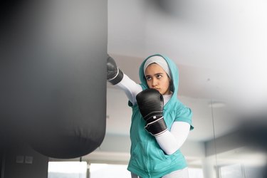 Person boxing in gym to demonstrate exercise isn't a replacement for therapy.
