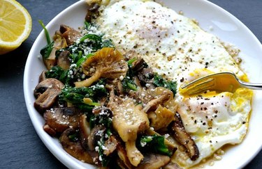 Wild Mushroom and Baby Spinach Egg Skillet on a white plate with a lemon wedge
