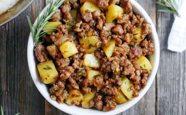 Spicy Rosemary Sausage and Potato Breakfast Hash Skillet in a white bowl