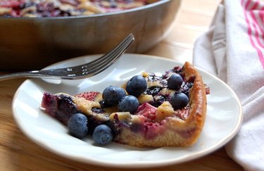 Skillet Berry Cobbler with blueberries on a white plate with a fork