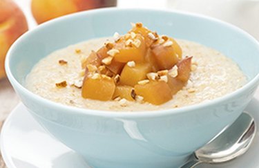 Peaches and Overnight Oats in a white bowl with a spoon