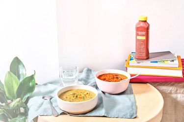 splendid spoon smoothie and soups on table with books and plant