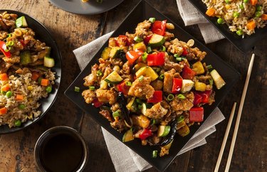 Chicken, Cashew and Vegetable Stir-fry on a black dish with chopsticks