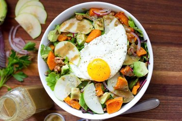 Fall Harvest Breakfast Salad in a white bowl with diced sweet potatoes and apple slices
