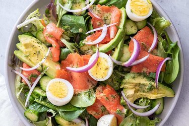 Smoked Salmon Salad Breakfast Salad in a white bowl with hardboiled eggs