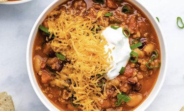 Pumpkin Turkey Chili topped with cheese and sour cream