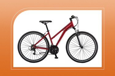 schwinn women's GTX 3 hybrid bike in maroon on an orange background