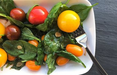 Cherry Tomato and Spinach Warm Salad  on white plate