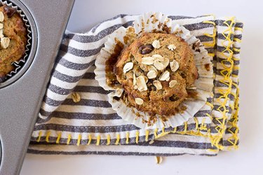 Banana Oatmeal Muffins with a navy blue and white striped cloth napkin