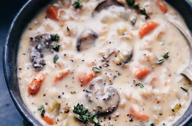 a closeup overhead photo of a bowl of creamy mushroom soup