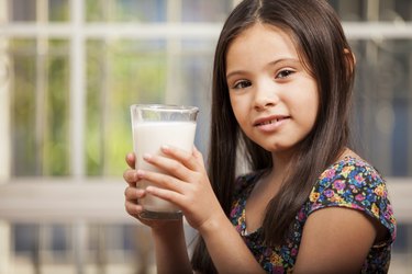 Cute girl with a glass of milk