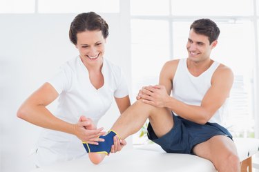 Doctor examining her patient foot