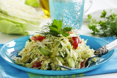 Young cabbage salad with cucumbers and tomatoes.