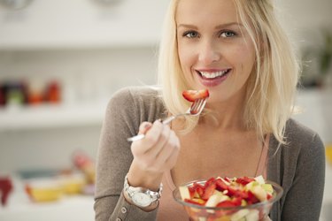 Woman Eating a Fruit Salad