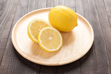 Fresh lemons on wooden plate