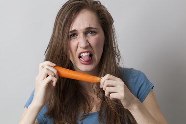 sick 20s woman having aversion in eating raw vegetables