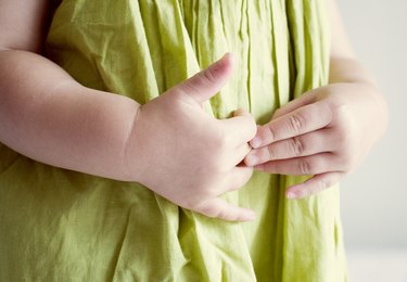 Child putting hands on stomach