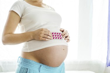 Pregnant person with pills
