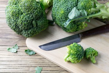 fresh broccoli on a cutting board and knife