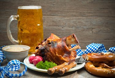 Roasted pork knuckle with pretzels and beer.