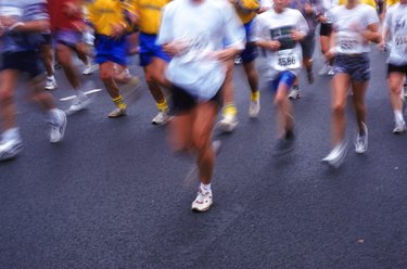 Marathon runners on road, low section