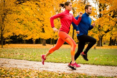 Couple jogging in autumn nature