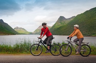 two cyclists relax biking