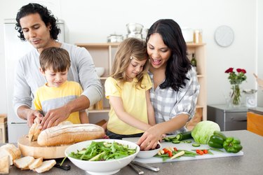 Positive family preparing lunch together