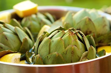 Close up of artichokes and lemon in a pot