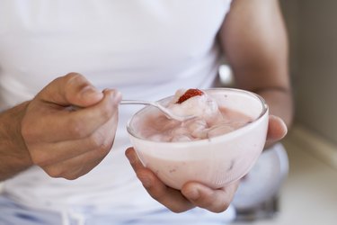 Hands holding yogurt