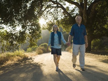 Mature couple walking down dirt road