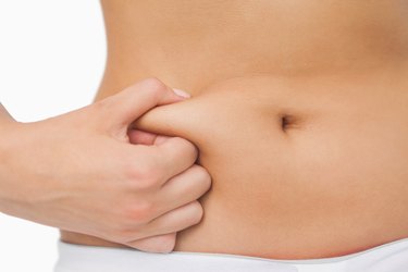 Young slim woman with little fat on her belly