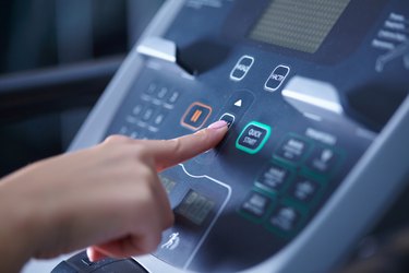 girl on a treadmill presses the button