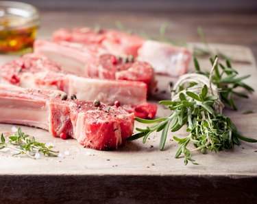 Raw meat, mutton, lamb rack on a wooden background